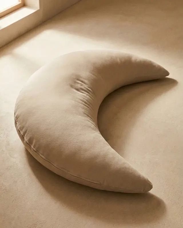 The Cove Classic in Oat, a plush crescent on a warm plaster floor